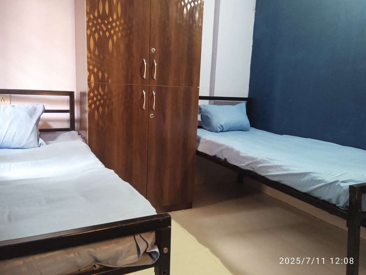 Spacious PG room with an attached balcony and natural light